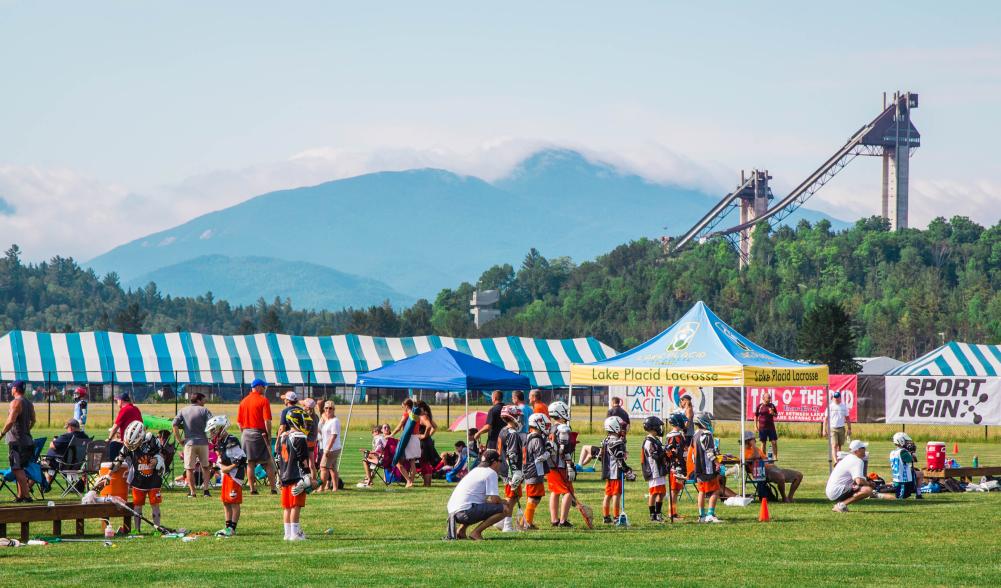 The Olympic ski jumps are seen in the background from a lacrosse tournament