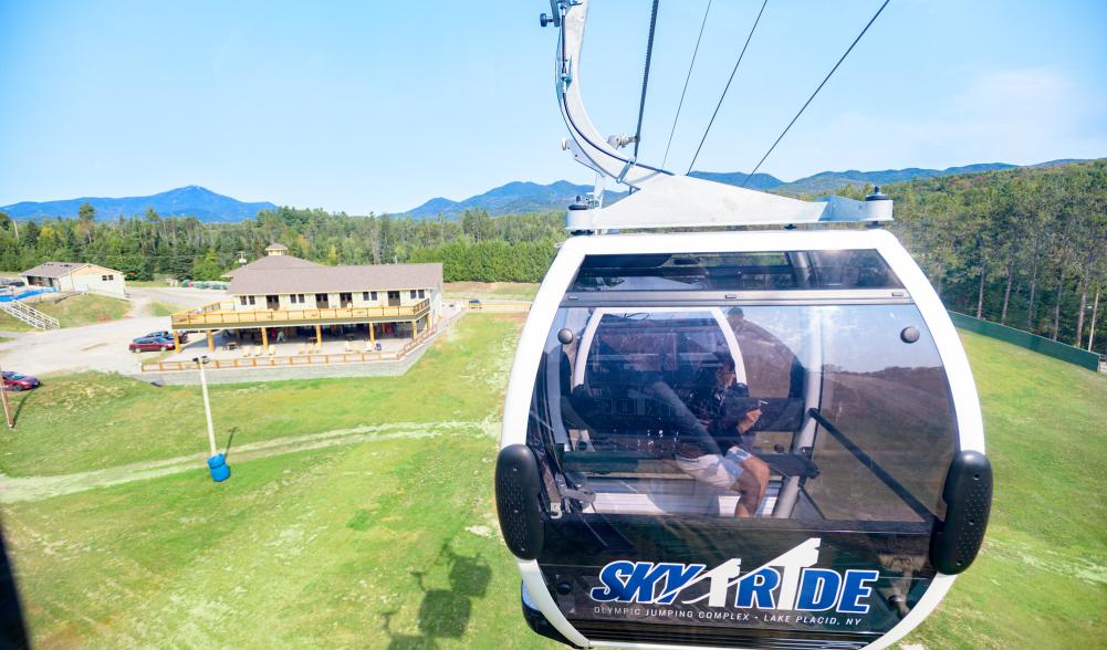 A glass gondola rises above the Intervales Lodge at the Olympic Jumping Complex.