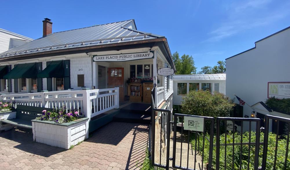 The exterior of the white and green-trimmed Lake Placid Library.