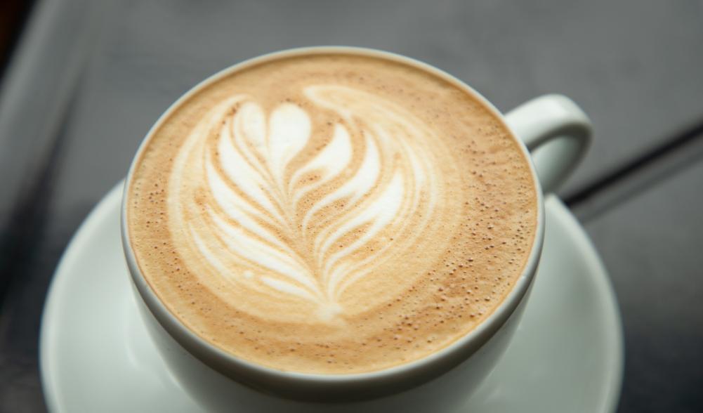 A freshly-made coffee with foam art in a white mug