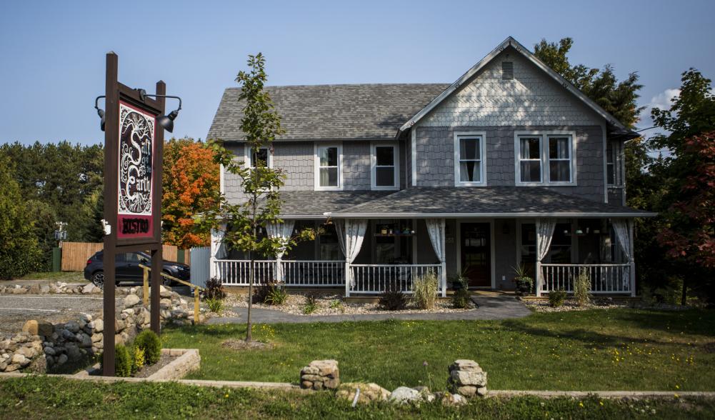 The cozy Salt of the Earth Bistro, a purple-grey building with a homey feel.