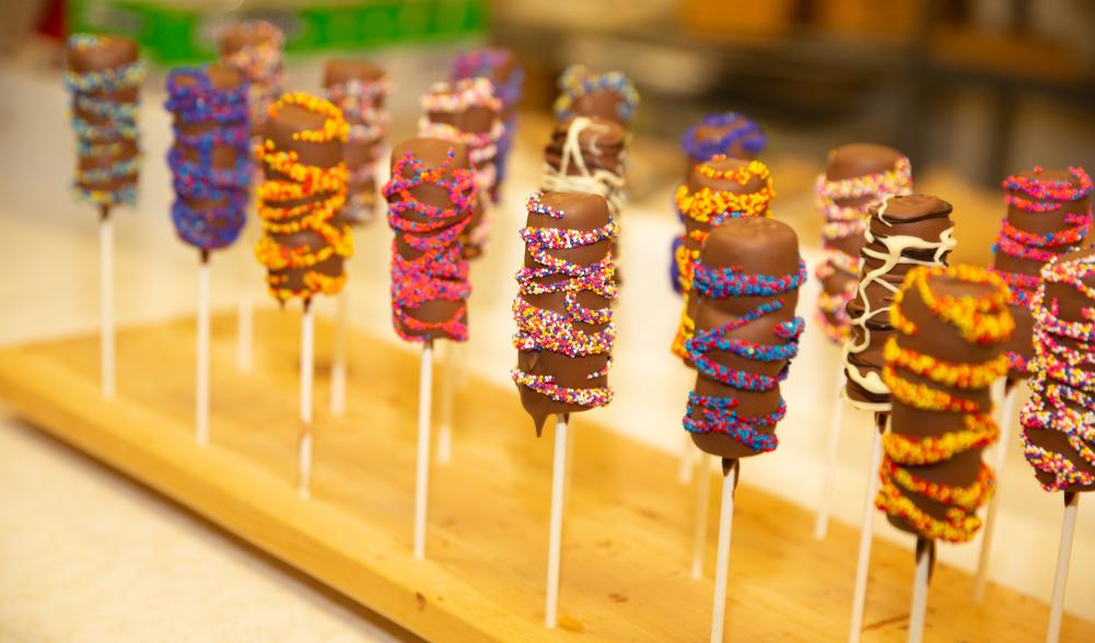Close up of chocolate covered marshmallow lollipops.