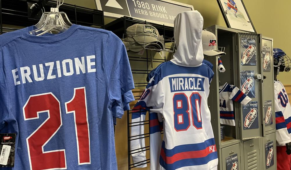 A display of tshirts, jerseys, and other hockey apparel and memorabilia in a shop.