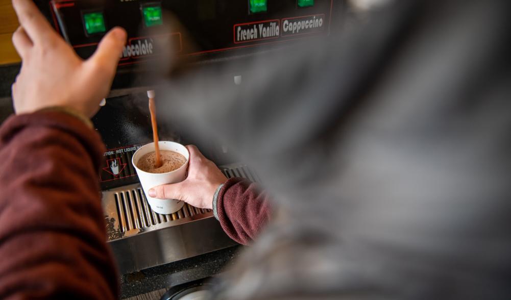 A man pours a cup of coffee.