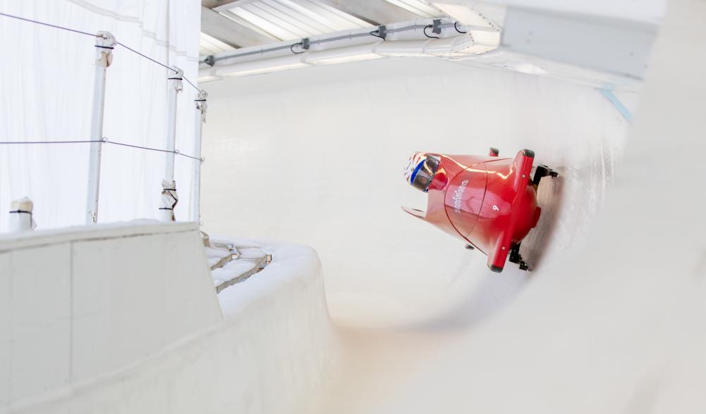 An adaptive bobsledder makes his way down the bobsled track in Lake Placid