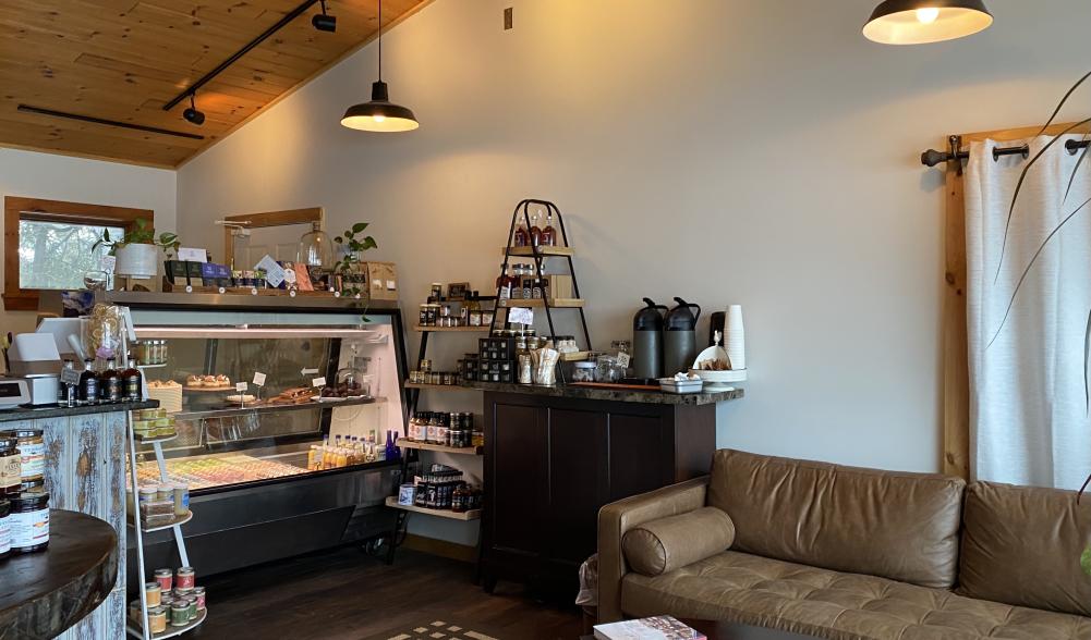 The casual couch-seating area and pastry shelf at Enuf