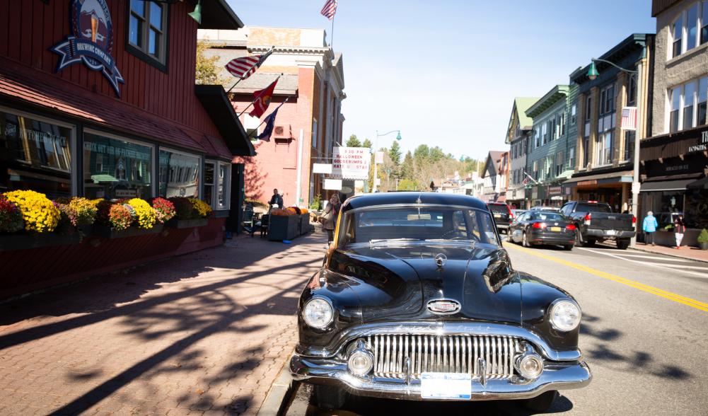 A classic car is parked in front of the entrance to the Great Adirondack Brewing Company.