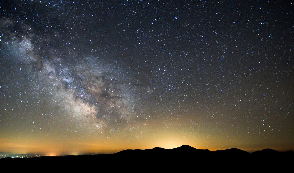 A mountain range silhouette at night.