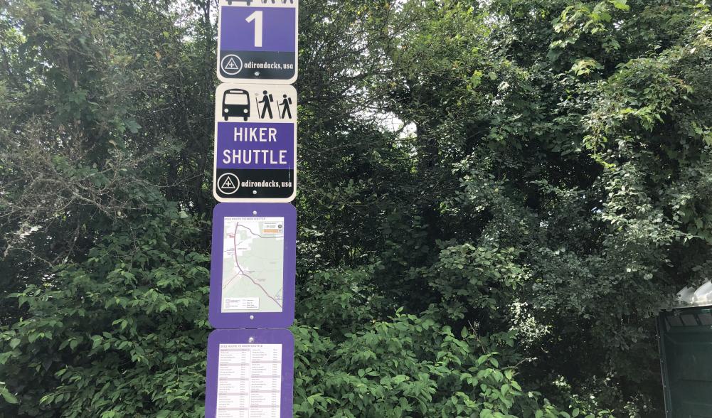 The hiking shuttle signs at Marcy Field