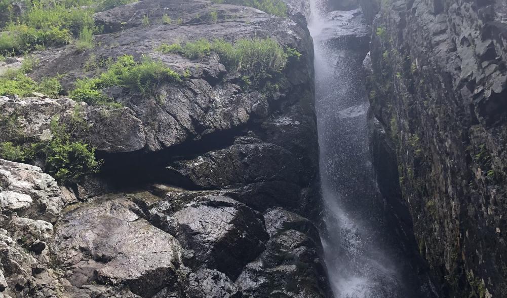 The rocky side of the falls on a sunny day