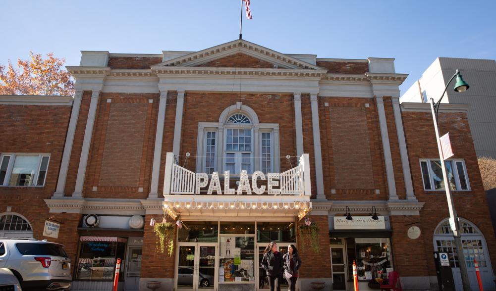 The exterior of a classic movie theater with brick facade and old-fashioned marquee.