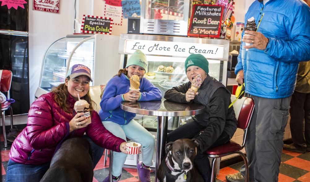 family of four enjoying different desserts