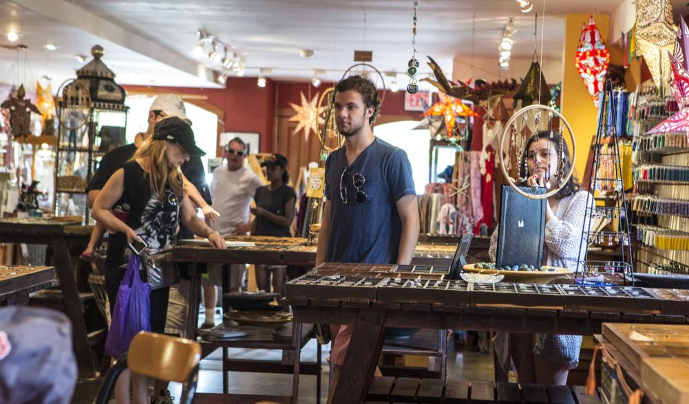 A colorfully decorated bead shop bustles with shoppers.