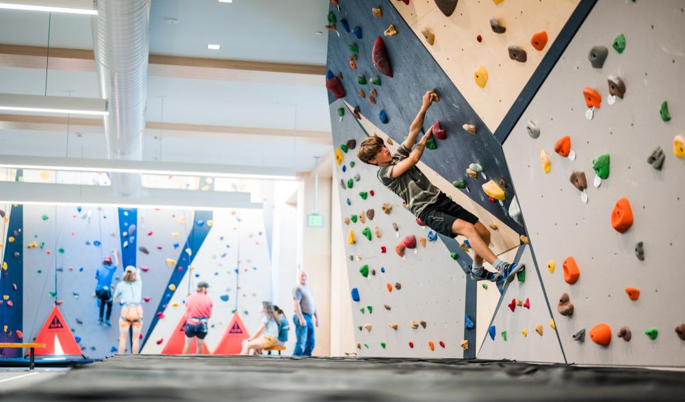 A boy climbs on the bouldering wall at the Van Hoevenberg Climbing Center