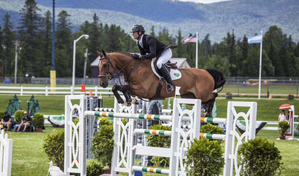 A horse jumps over a hurdle at the Lake Placid Horse Show grounds