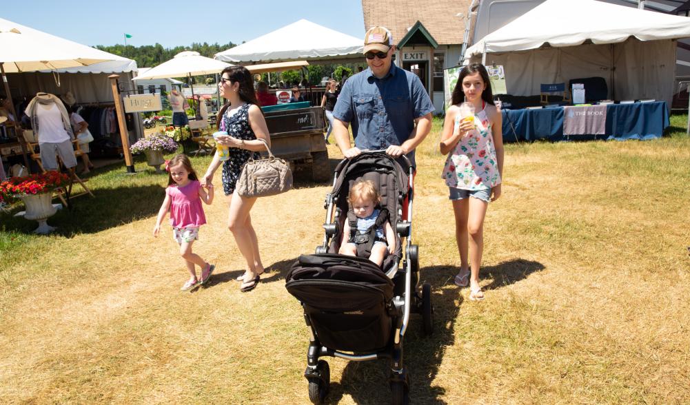 A family strolls together at the Lake Placid Horse Show grounds