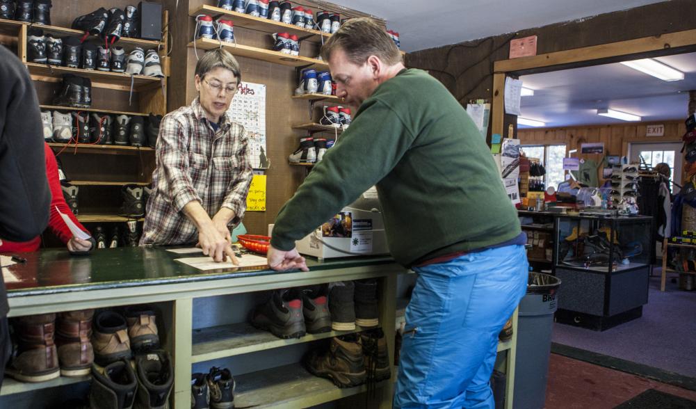 A man buys used gear at the welcome center.