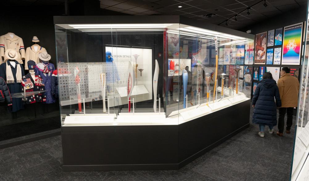 A glass case filled with Olympic memorabilia in a museum