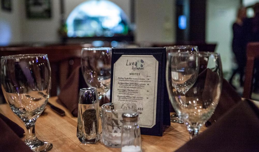 Wine glasses surround Luna Restaurant's drink list.