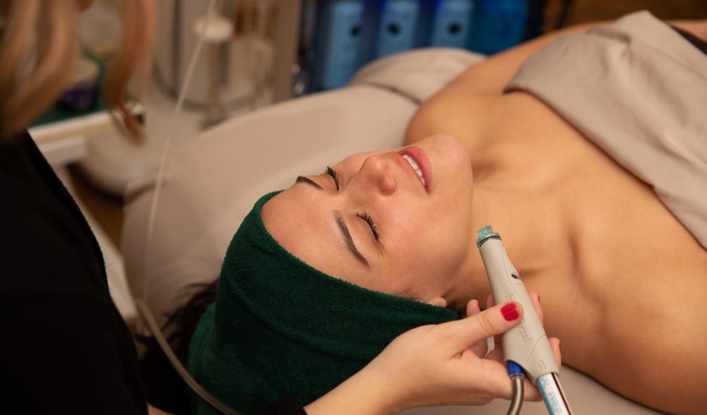 A woman gets a facial from a spa.