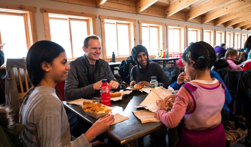 A family eats at a ski mountain lodge