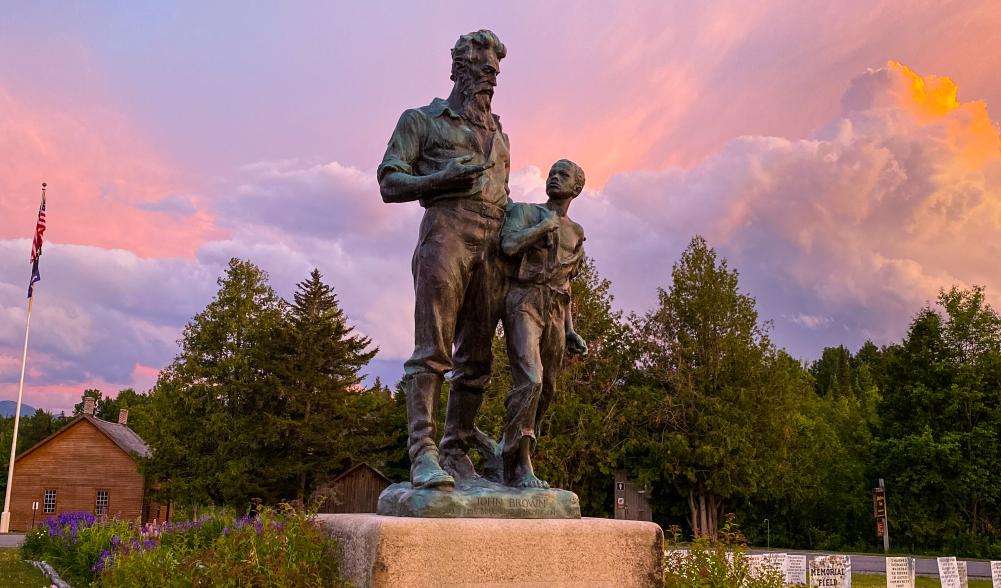 A statue of a man and child at John Brown Farm Historic site.