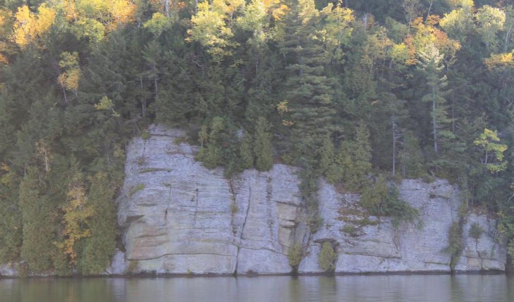 A white rock slab that leads into water.