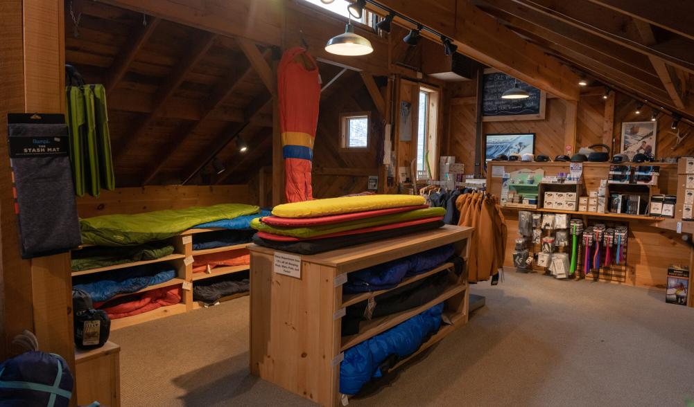 A table of sleeping gear in a gear shop