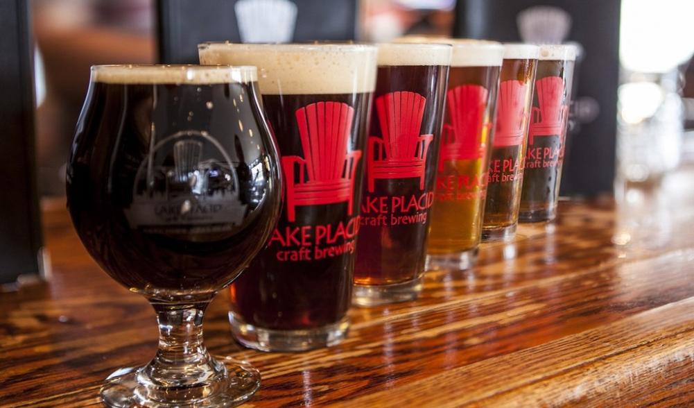 A line of glass cups with "Lake Placid Craft Brewing" printed on the side.