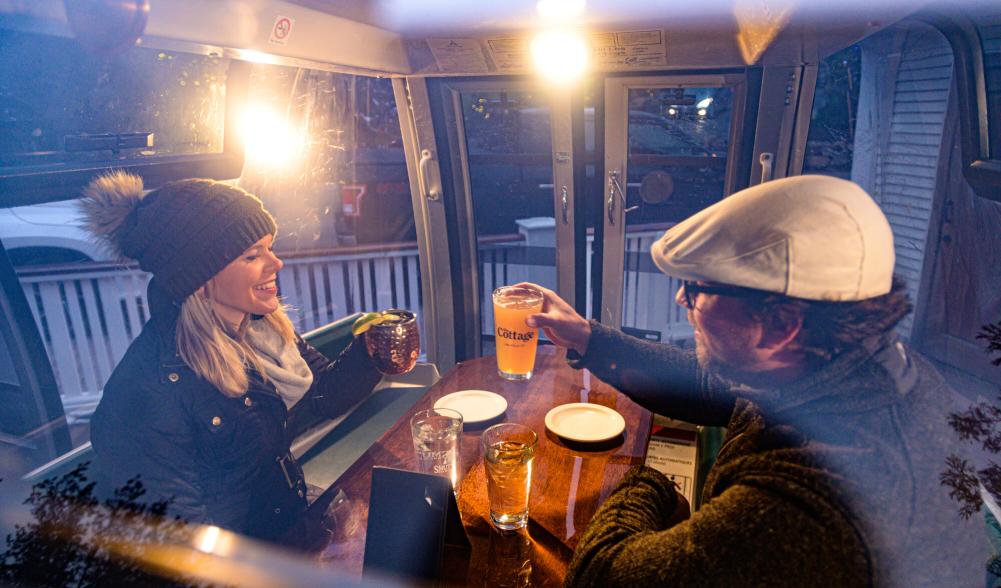 Man and woman inside gondola eating dinner