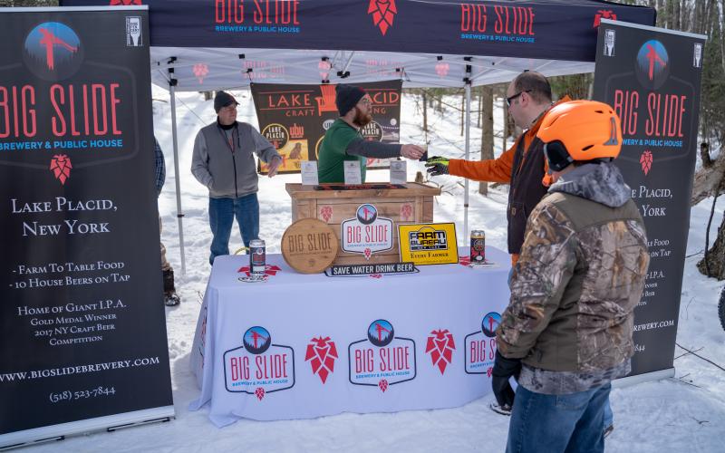 Snowshoers getting Big Slide Brewery beer.
