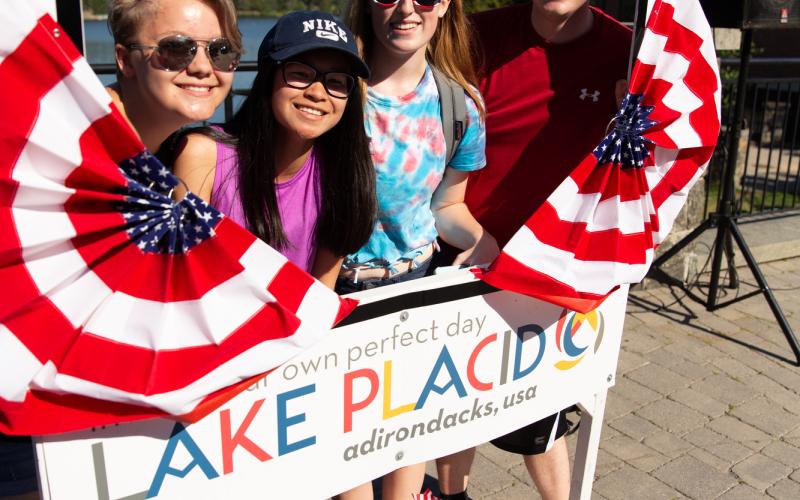 three teenagers pose for a photo in the Lake Placid selfie frame
