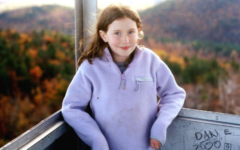 Girl standing in a firetower during Autumn
