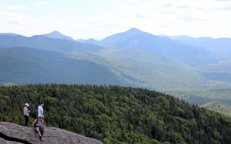 Hikers at the summit of Cascade mountain during a Lake Placid vacation.
