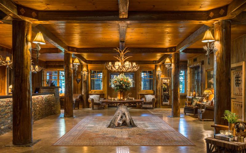 Lobby with wooden beams and marble floor.