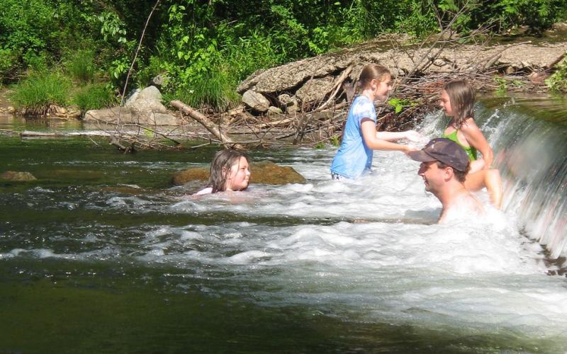 People relaxing and playing in a river