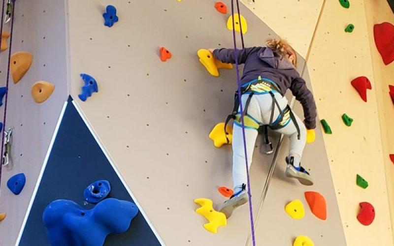 Climber nears the top of the climbing wall