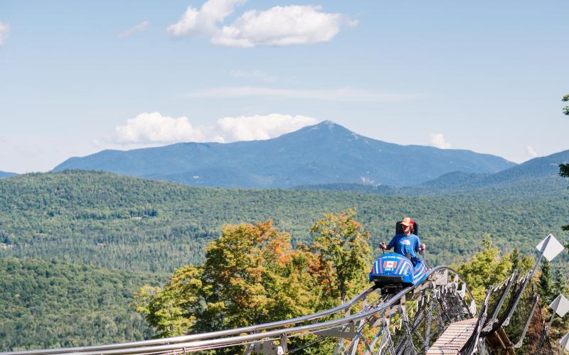 Cliffside coaster with a stunning view of mountains in the backfrouund