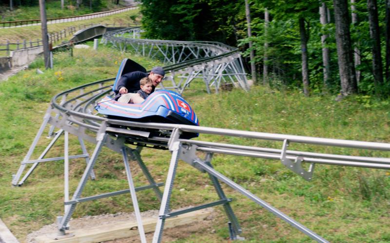 Rider zooms down the cliffside coaster