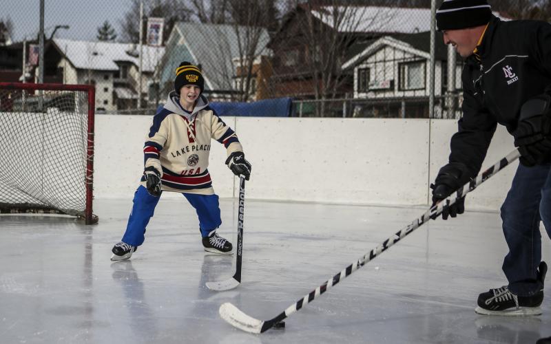 A father and son play hockey
