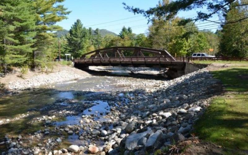 A metal bridge over a rocky river