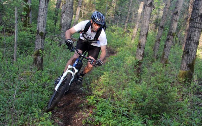 Mountain biker takes a turn on a single track trail