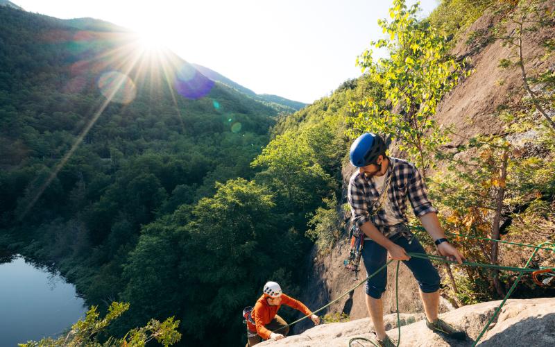 A belayer brings up his follower