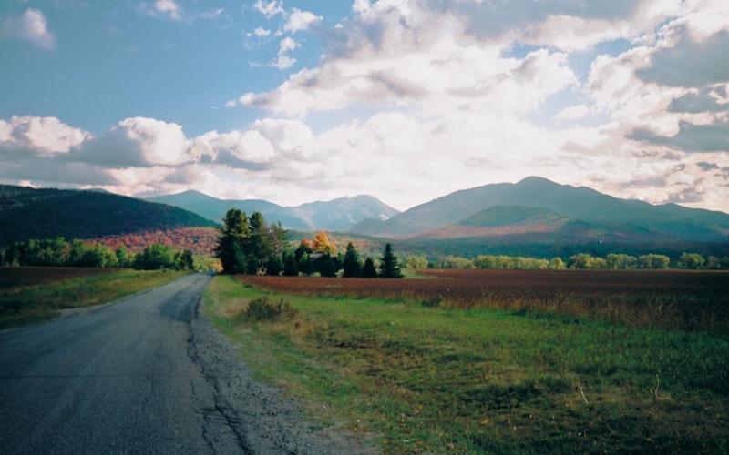 A view of mountains in the fall from a road