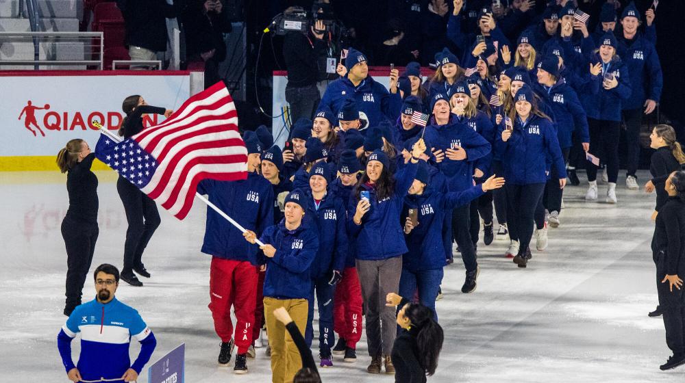 American athletes march out onto a hockey rink.